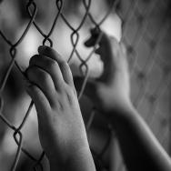 Hands on chainlink fence