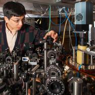 Cheng Chin in the lab with a lot of equipment