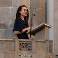 Assoc. Prof. Kimberly Kay Hoang delivering the Aims of Education address to first-year students.